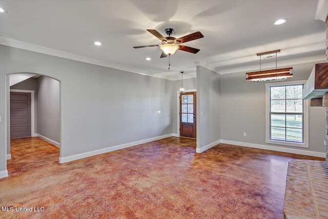 empty room with ceiling fan and crown molding