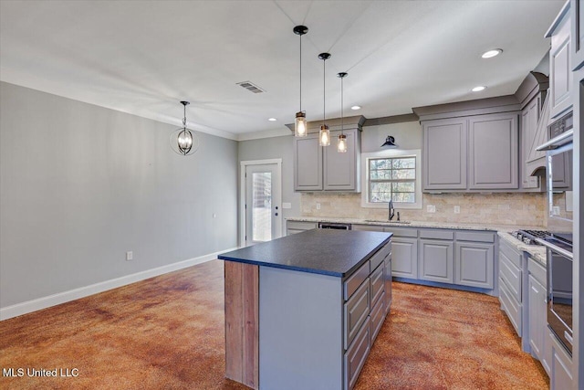 kitchen featuring gray cabinetry, sink, a kitchen island, and hanging light fixtures