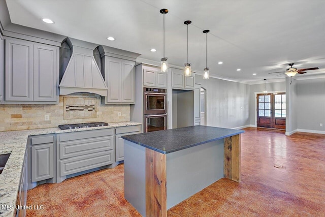 kitchen with premium range hood, gray cabinets, a center island, and stainless steel appliances