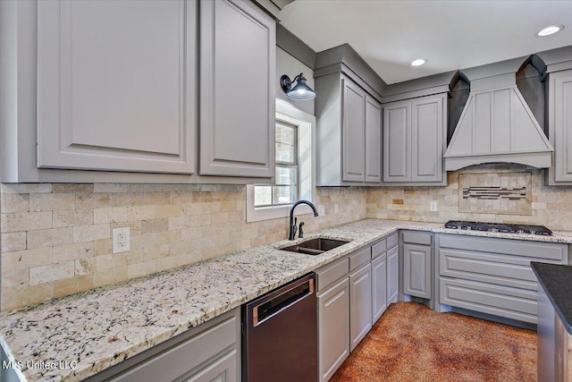 kitchen featuring gray cabinetry, light stone countertops, sink, stainless steel appliances, and custom range hood