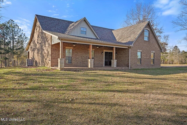 view of front of property with central AC and a front yard