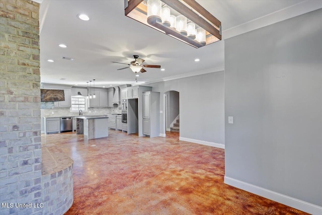 kitchen featuring tasteful backsplash, gray cabinetry, ceiling fan, dishwasher, and a kitchen island