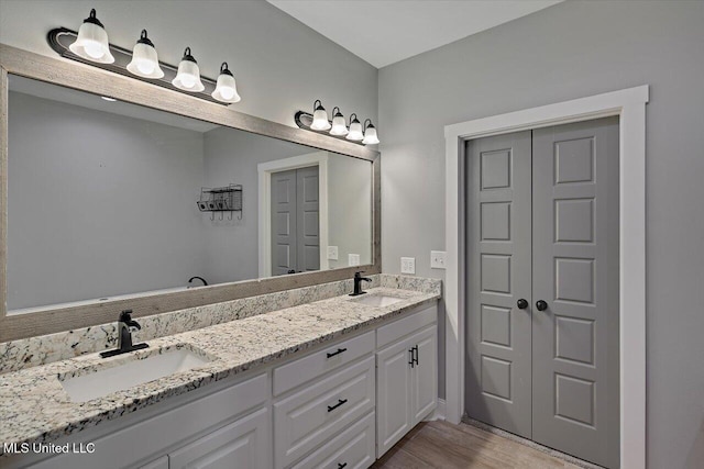 bathroom featuring vanity and hardwood / wood-style flooring