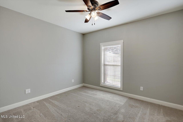 spare room featuring ceiling fan and light colored carpet