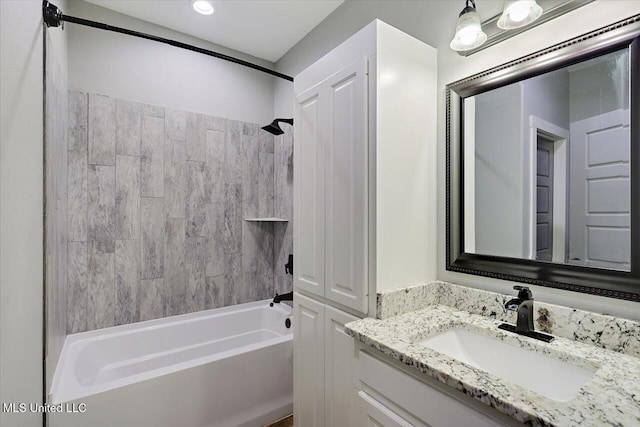 bathroom with vanity and tiled shower / bath