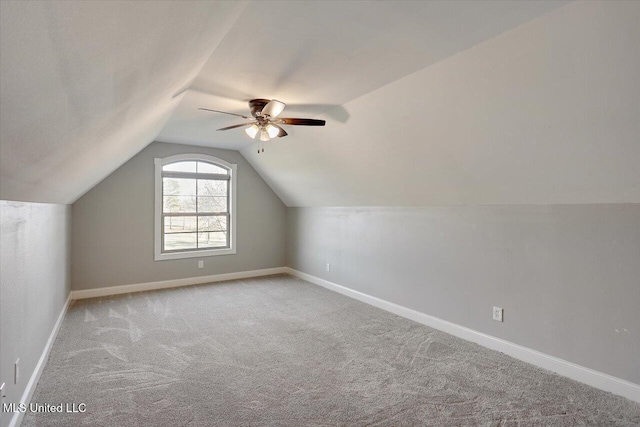 bonus room featuring light carpet, vaulted ceiling, and ceiling fan