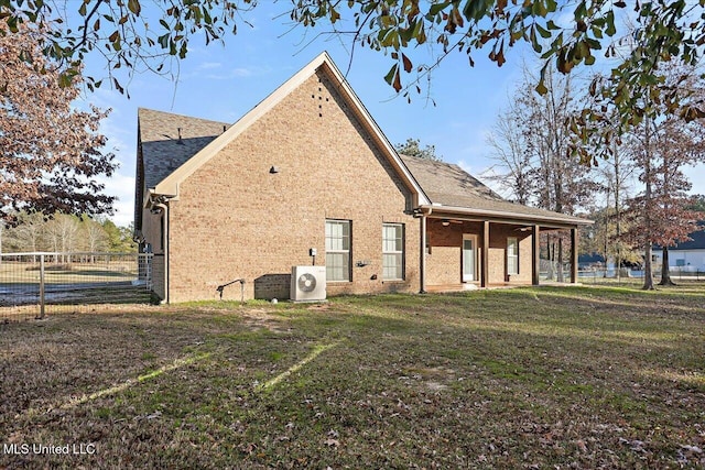 back of house with a lawn and ac unit