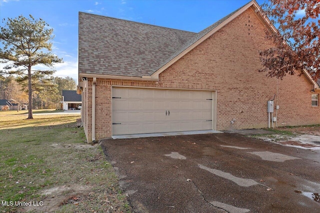 garage featuring a lawn