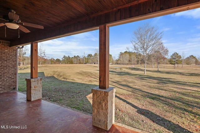 view of yard featuring a patio area and ceiling fan