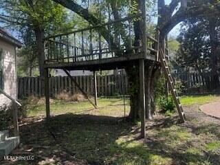 56 John St, Clarksdale, MS 38614 - fenced yard with a wooden deck