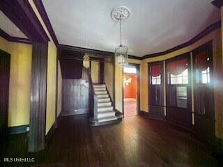 56 John St, Clarksdale, MS 38614 - foyer entrance with wood finished floors, crown molding, baseboards, a chandelier, and stairway