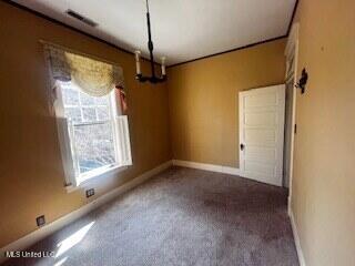 56 John St, Clarksdale, MS 38614 - carpeted empty room featuring a chandelier and baseboards