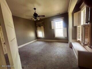 56 John St, Clarksdale, MS 38614 - unfurnished room featuring ceiling fan, carpet, and baseboards