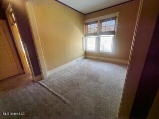 56 John St, Clarksdale, MS 38614 - carpeted empty room with baseboards
