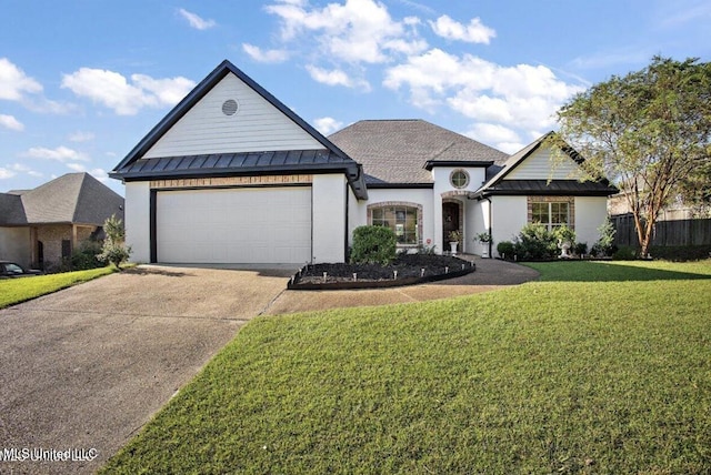 view of front of house with a front yard and a garage