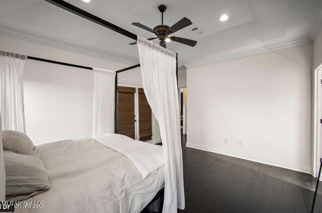 bedroom featuring dark hardwood / wood-style flooring, ceiling fan, and crown molding