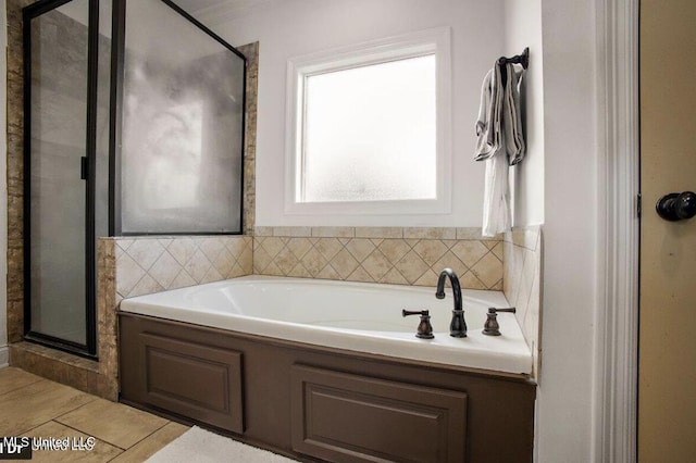 bathroom with tile patterned floors and independent shower and bath