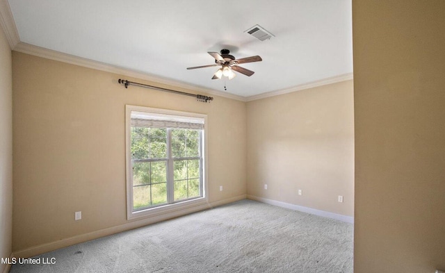 unfurnished room with light colored carpet, ceiling fan, and crown molding