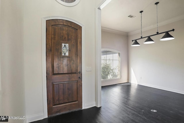 foyer entrance with crown molding and dark hardwood / wood-style flooring