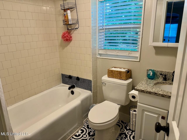 full bathroom featuring toilet, tiled shower / bath, vanity, and tile patterned flooring