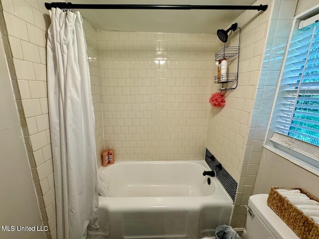 bathroom with shower / tub combo with curtain and toilet