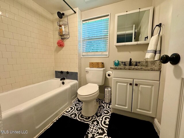 full bathroom with vanity, tiled shower / bath combo, toilet, and tile patterned flooring