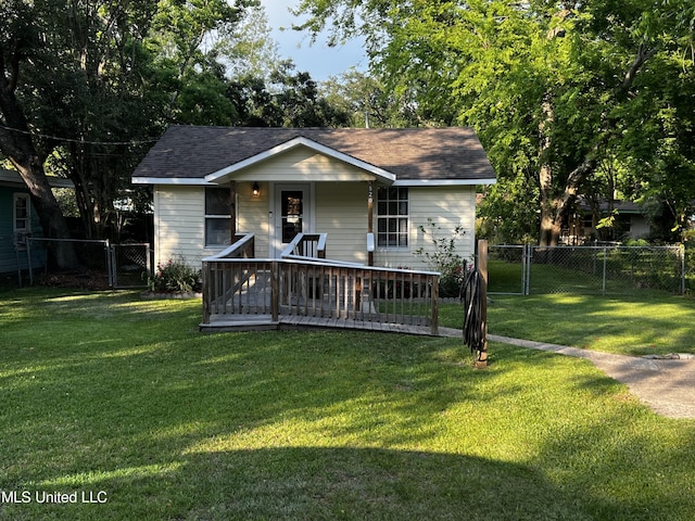 view of front of house with a gate, a shingled roof, a front lawn, and fence