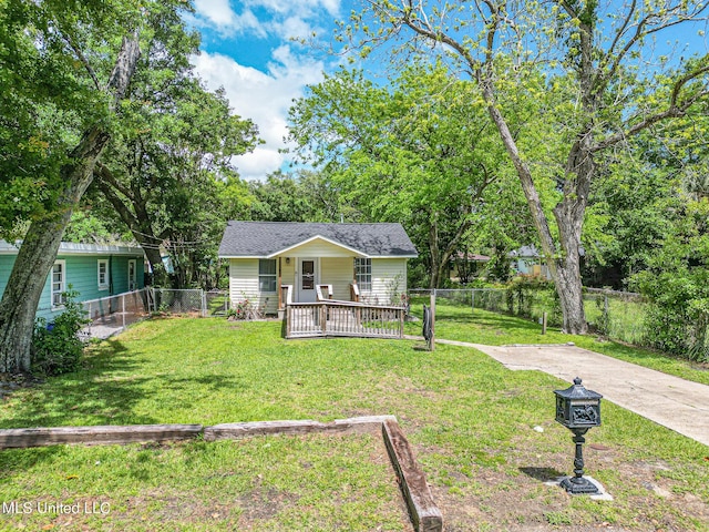 bungalow-style home with a porch, fence private yard, a shingled roof, and a front yard