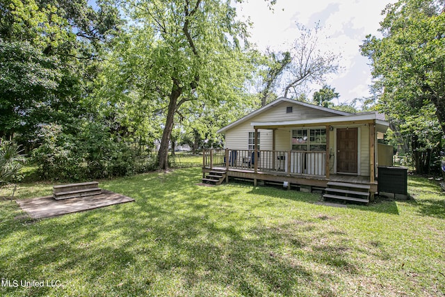 rear view of property with a deck and a lawn