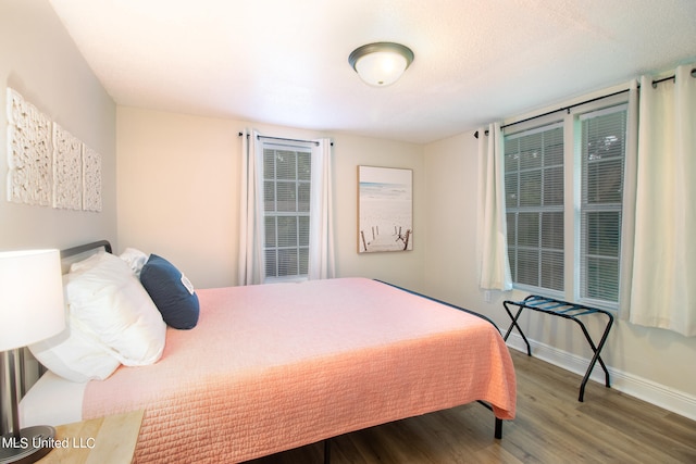 bedroom with wood-type flooring