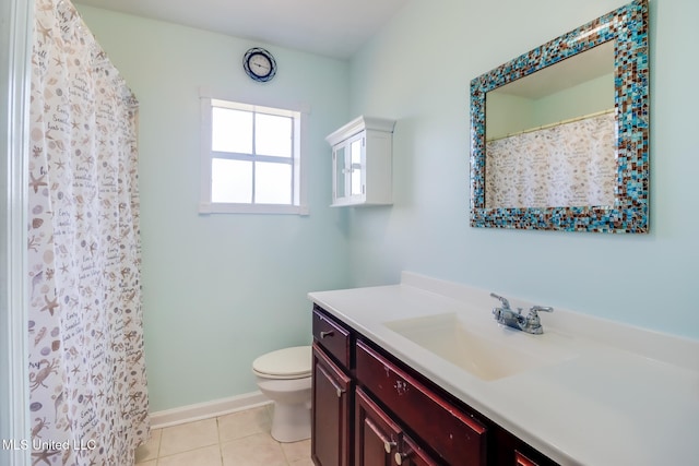 bathroom featuring tile patterned floors, vanity, toilet, and baseboards