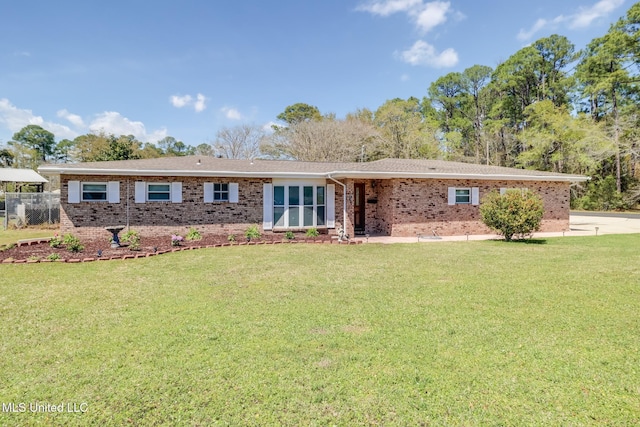 ranch-style home featuring a front yard and brick siding