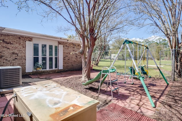 view of patio featuring a gate, central air condition unit, playground community, and fence
