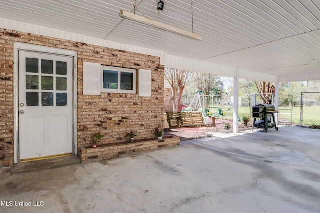 view of patio featuring area for grilling and fence
