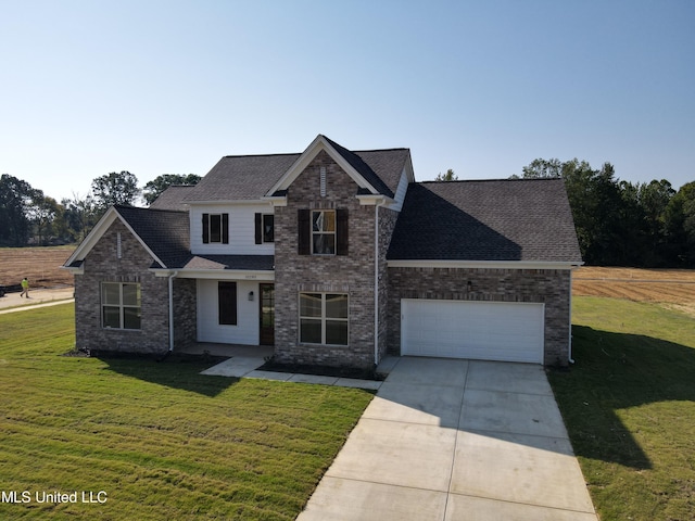 view of front of house featuring a garage and a front lawn