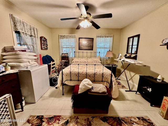 tiled bedroom featuring ceiling fan