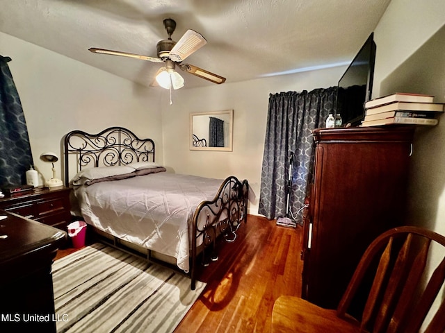 bedroom with hardwood / wood-style flooring and ceiling fan