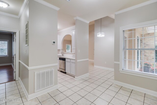 2616 Rue Palafox, Biloxi, MS 39531 - spare room with light tile patterned floors, plenty of natural light, ornamental molding, arched walkways, and baseboards