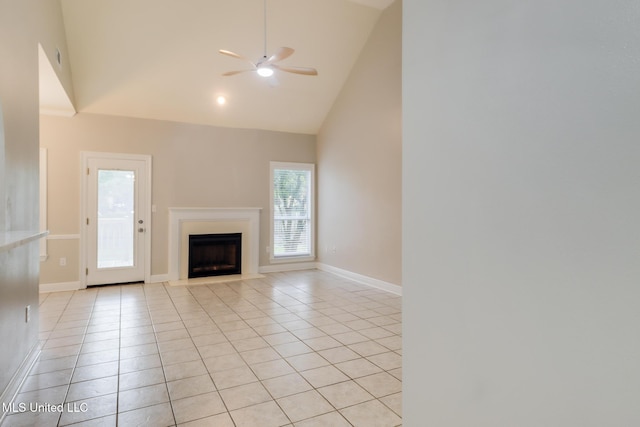 2616 Rue Palafox, Biloxi, MS 39531 - unfurnished living room featuring light tile patterned floors, a ceiling fan, high vaulted ceiling, a fireplace, and baseboards