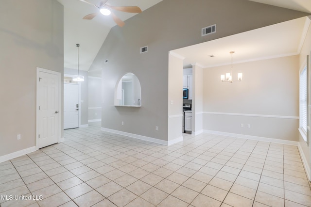 2616 Rue Palafox, Biloxi, MS 39531 - empty room featuring light tile patterned floors, a chandelier, a ceiling fan, high vaulted ceiling, and baseboards