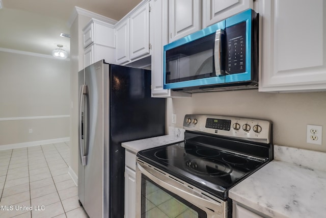 2616 Rue Palafox, Biloxi, MS 39531 - kitchen with appliances with stainless steel finishes, white cabinets, crown molding, light tile patterned floors, and light stone countertops