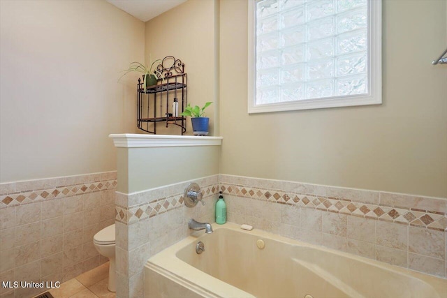 911 Tetbury Pl, Brandon, MS 39047 - full bathroom with toilet, a garden tub, tile walls, a wainscoted wall, and tile patterned floors