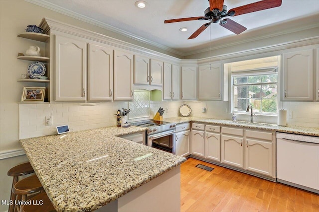 911 Tetbury Pl, Brandon, MS 39047 - kitchen with dishwasher, stainless steel stove, a sink, a peninsula, and open shelves