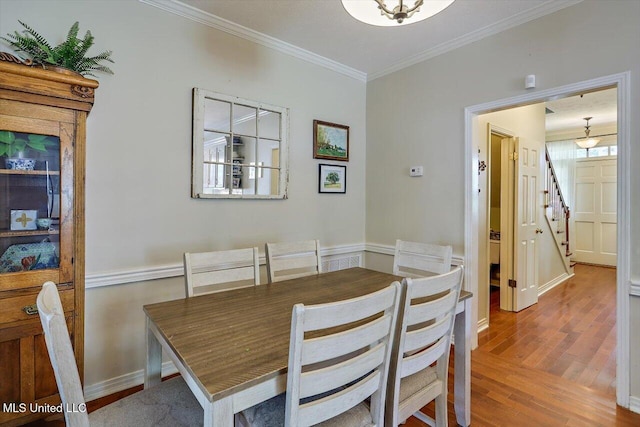 911 Tetbury Pl, Brandon, MS 39047 - dining area featuring crown molding, wood finished floors, stairs, and baseboards