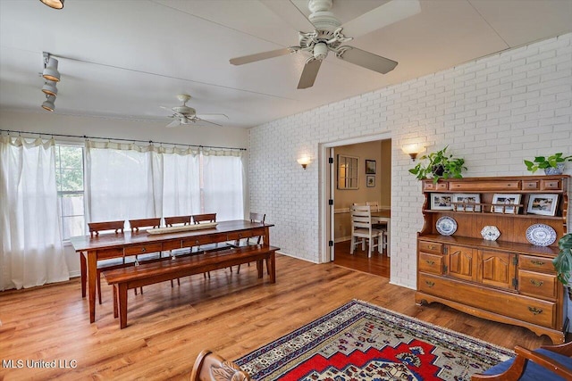 911 Tetbury Pl, Brandon, MS 39047 - dining space featuring brick wall, healthy amount of natural light, ceiling fan, and wood finished floors