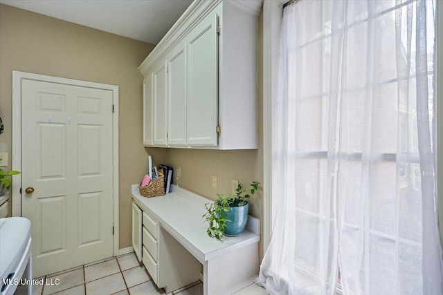 911 Tetbury Pl, Brandon, MS 39047 - clothes washing area with light tile patterned flooring, cabinet space, and washing machine and clothes dryer