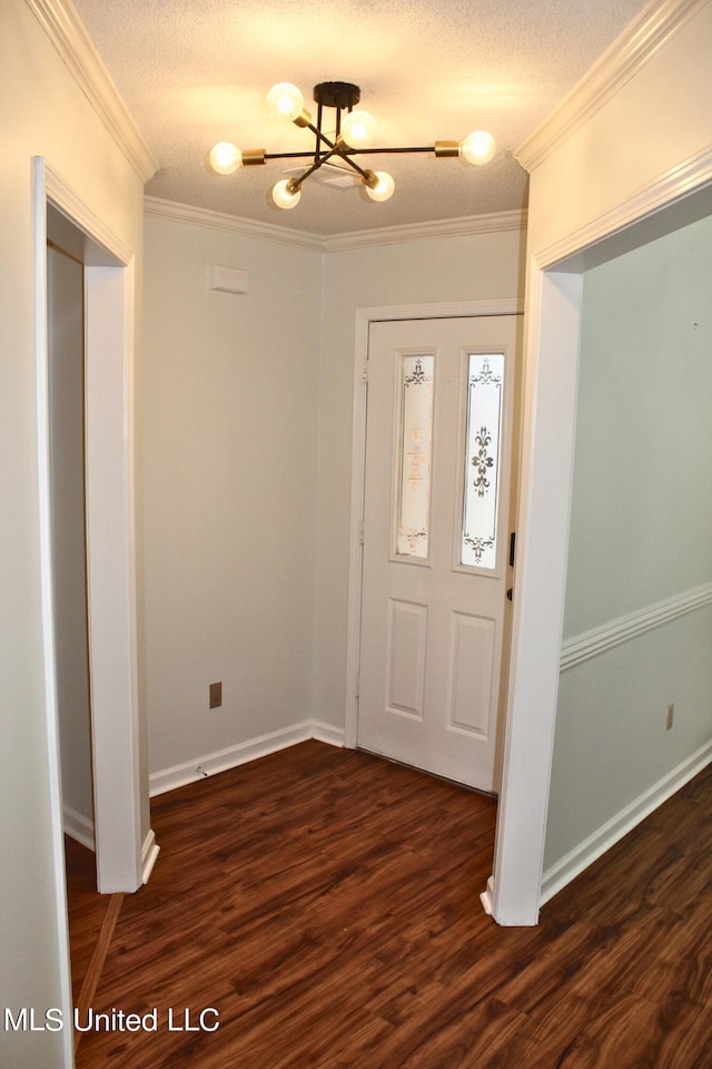 foyer entrance featuring crown molding, a textured ceiling, and dark hardwood / wood-style floors