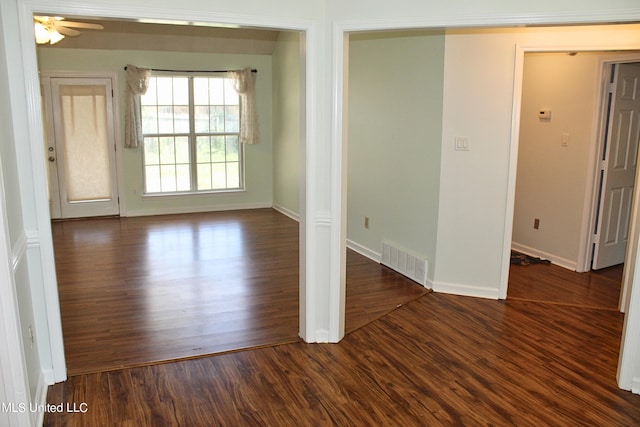 unfurnished room with ceiling fan and dark hardwood / wood-style flooring