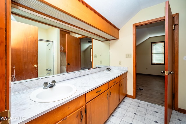 bathroom featuring tile patterned floors, lofted ceiling, and vanity