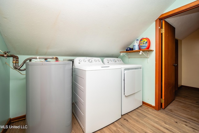 washroom featuring gas water heater, light hardwood / wood-style flooring, and washer and dryer